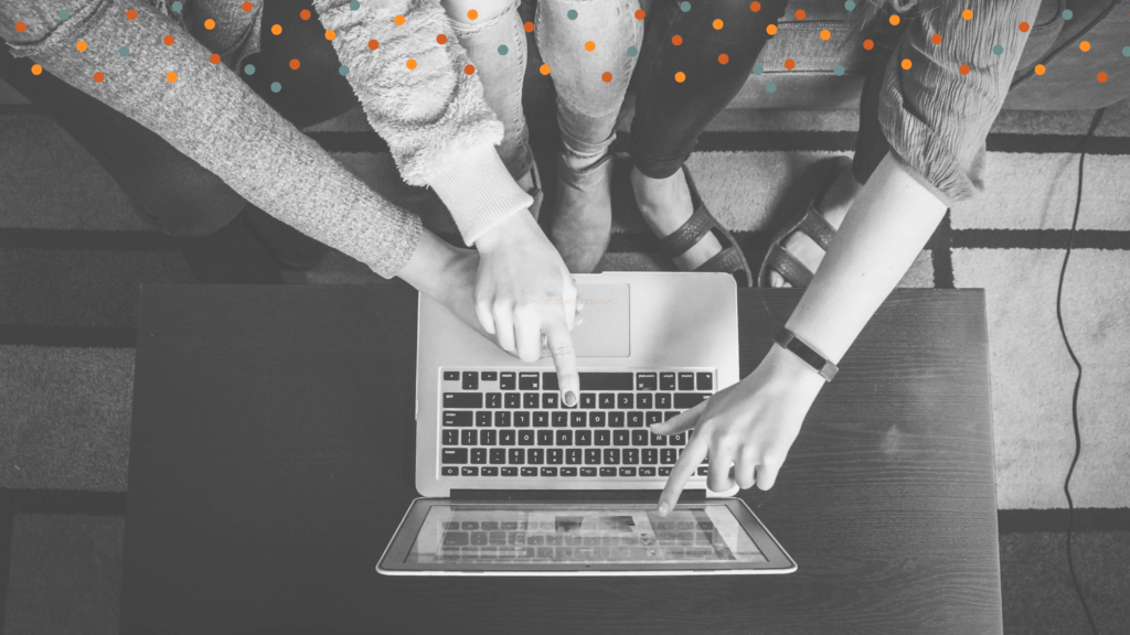 Hands pointing to something on a laptop screen